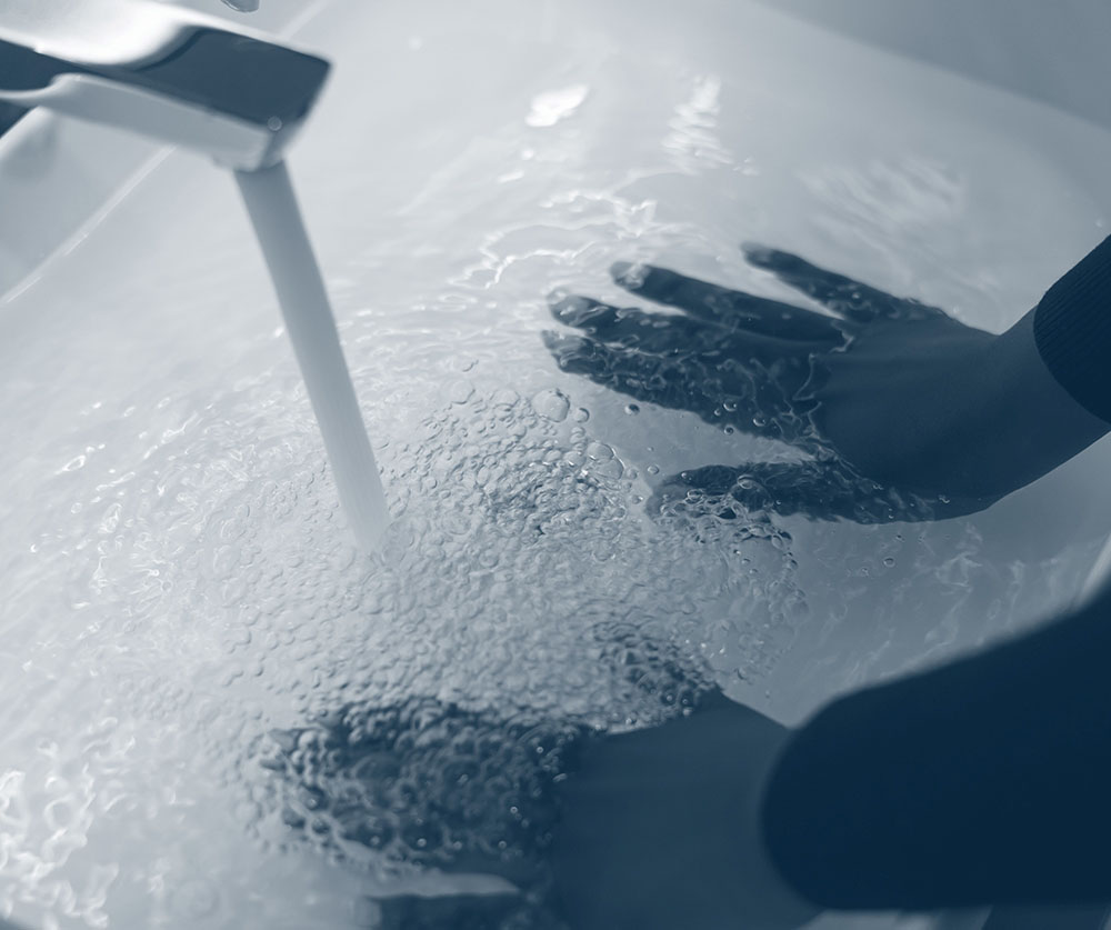 hand washing with clean water coming from a tap